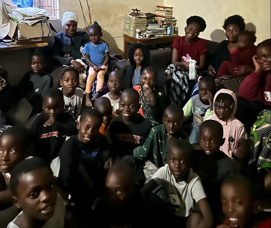 Forty children gathered together inside the school